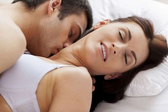 Excited man and woman in bed